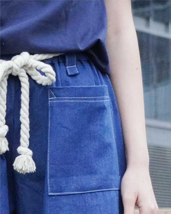Side detail view showing the belt loop, stitching, and rope belt on Oxford blue Kamon Pants at Grandmama Store in Hong Kong.