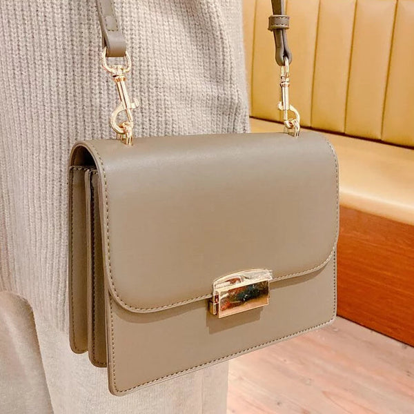 vTaupe Square Side Bag with Gold Buckle worn crossbody at Grandmama Store in Hong Kong.