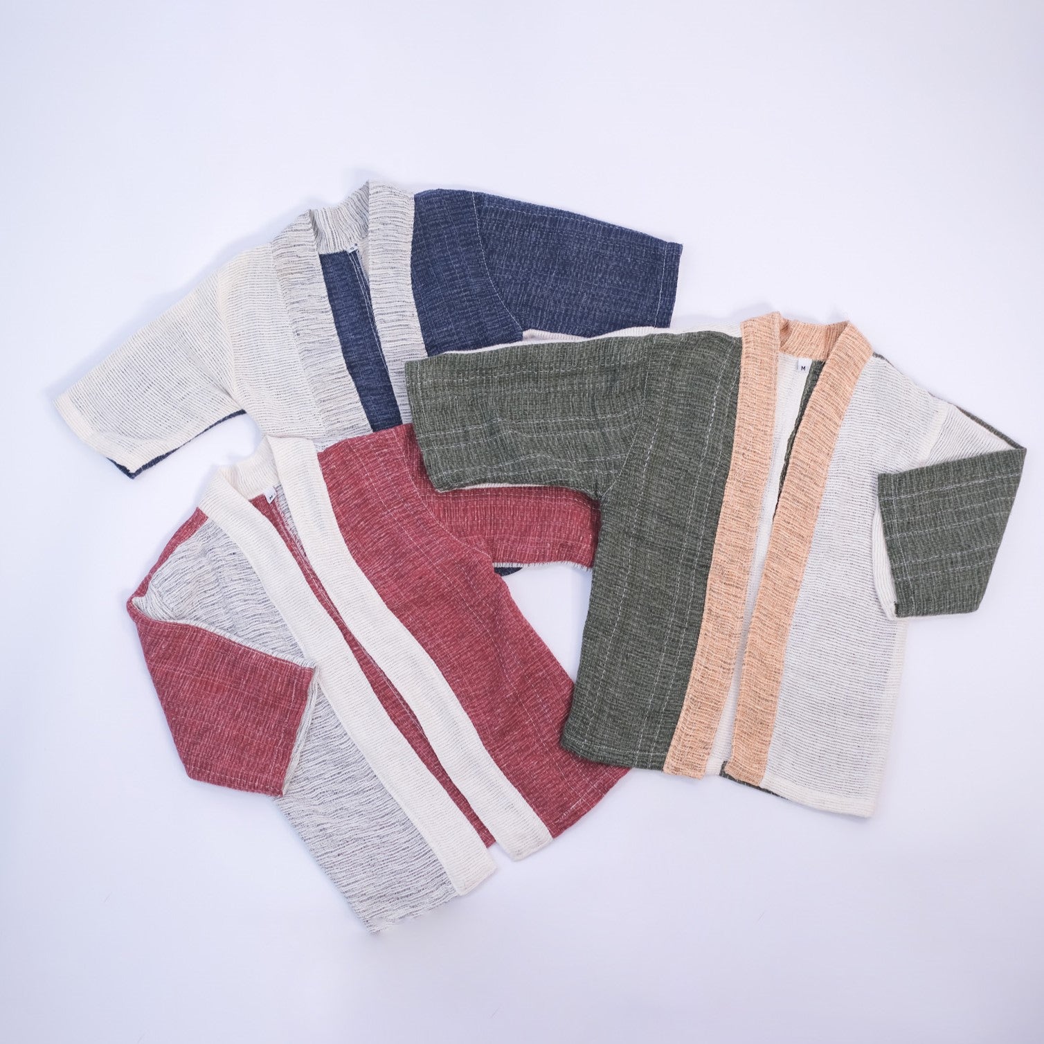 Three Hand-cranked Kids Kimono jackets laid out flat in all available colorways at Grandmama Store in Hong Kong.