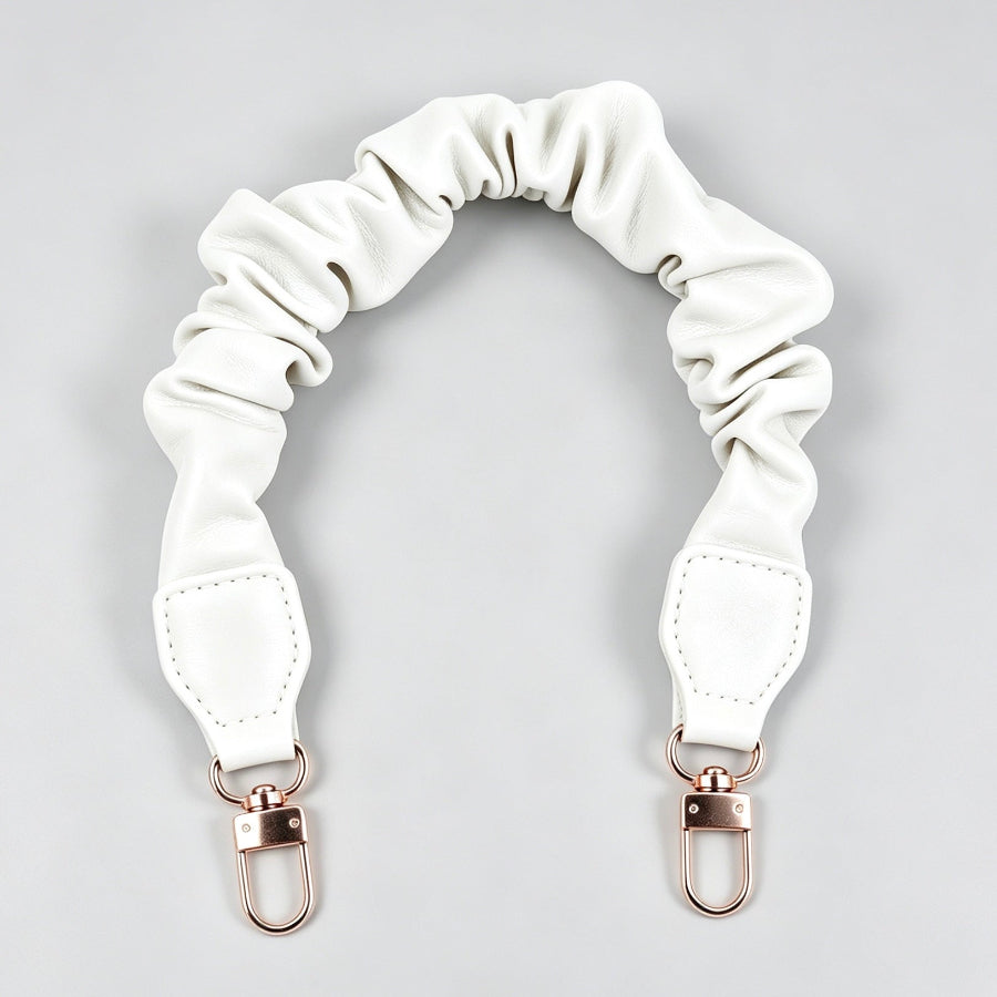 White ruffled scrunchie leather purse strap accessory with gold clasps at Grandmama Store in Hong Kong.