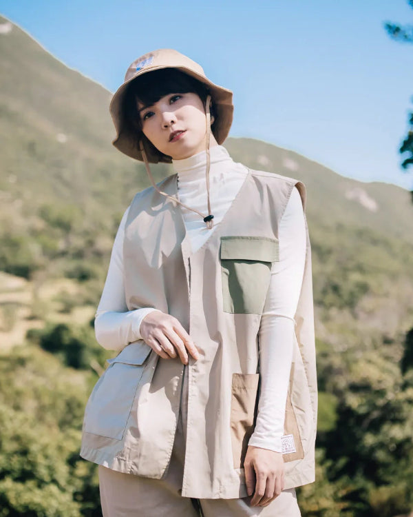 Woman Model wearing the beige Yama Workwear Bucket Hat outdoors at Grandmama Store in Hong Kong.