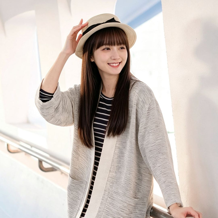 Woman in straw hat wearing off-white Hand-cranked Kimono outdoors at Grandmama Store in Hong Kong.