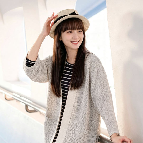 Woman in straw hat wearing off-white Hand-cranked Kimono outdoors at Grandmama Store in Hong Kong.