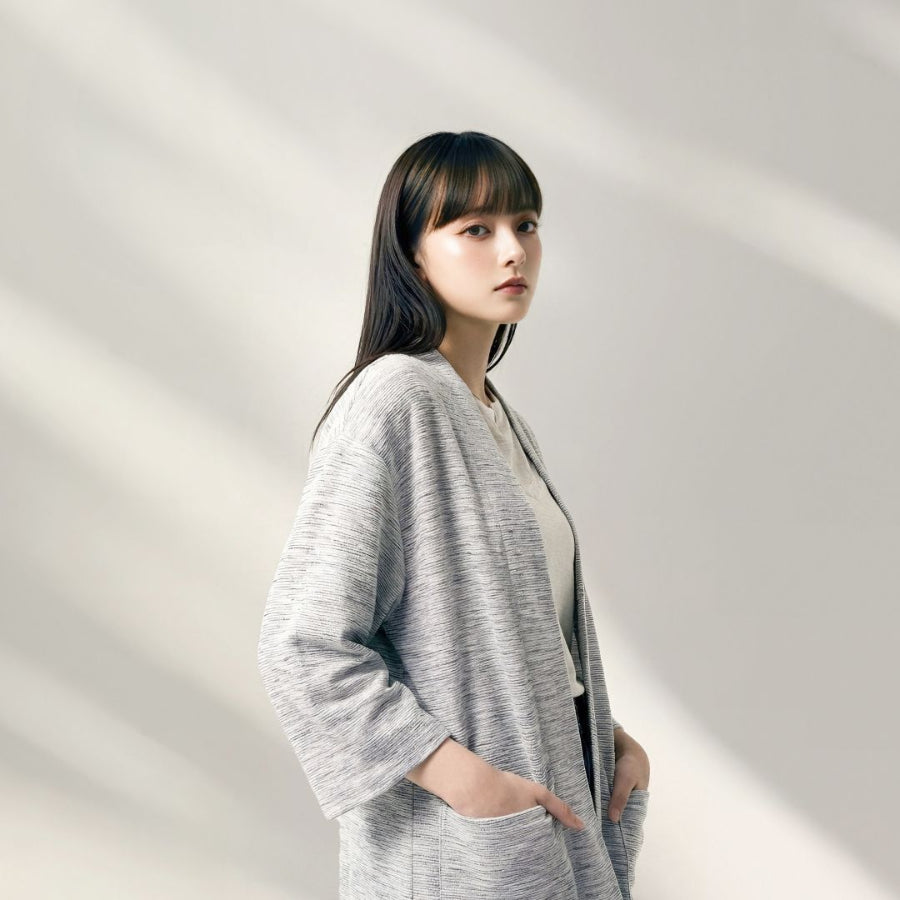 Woman modeling a light grey Hand-cranked Kimono cardigan in a studio setting at Grandmama Store in Hong Kong.