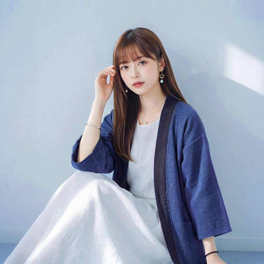 Woman modeling dark navy Hand-cranked Kimono seated portrait at Grandmama Store in Hong Kong.