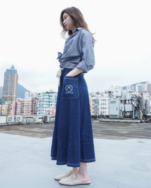 Woman modeling the navy blue Kamon Denim Dress-Fujisan on an urban rooftop at Grandmama Store in Hong Kong.