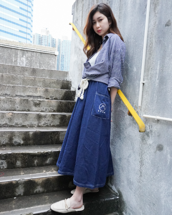 Woman modeling the navy blue Kamon Denim Dress-Fujisan on outdoor steps at Grandmama Store in Hong Kong.