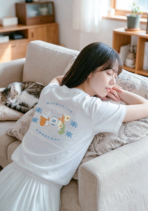 Woman resting on a sofa wearing the white Dancing Cat Tee at Grandmama Store in Hong Kong.
