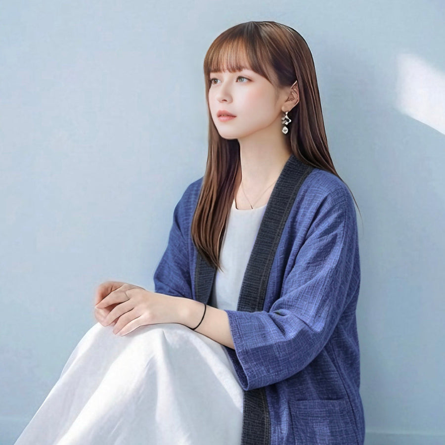 Woman sitting in dark navy Hand-cranked Kimono cardigan at Grandmama Store in Hong Kong.