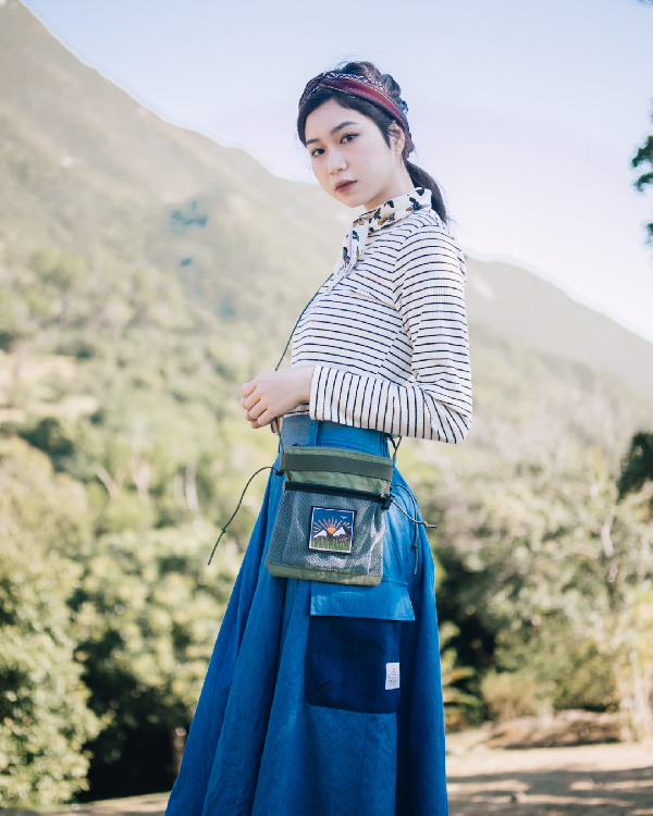 Woman standing outdoors in the light blue Yama Ocean Pocket Dress at Grandmama Store in Hong Kong.
