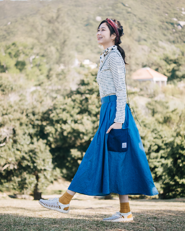 Woman walking in the light blue Yama Ocean Pocket Dress at Grandmama Store in Hong Kong.