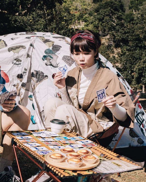 Woman wearing beige Morikawa Yama Kimono Jacket at a campsite at Grandmama Store in Hong Kong.
