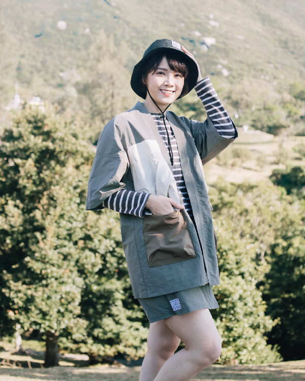 Woman wearing greyish Morikawa Yama Kimono Jacket and bucket hat outdoors at Grandmama Store in Hong Kong.