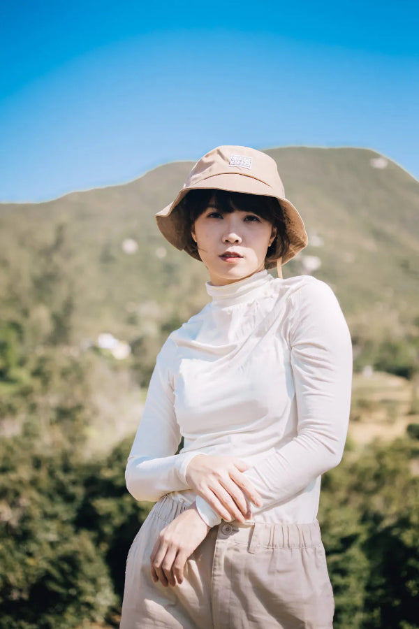 Woman wearing the beige Yama Workwear Bucket Hat outdoors at Grandmama Store in Hong Kong.