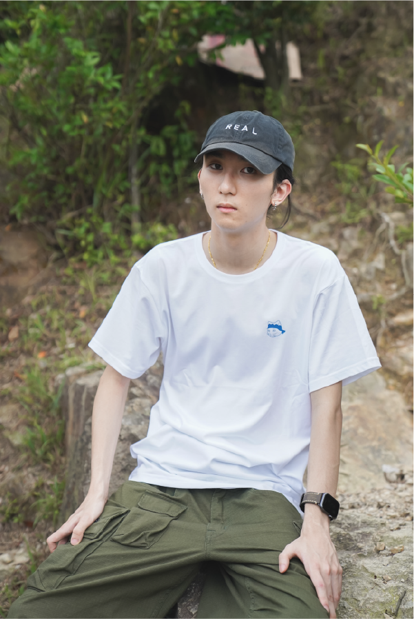 man-in-black-cap-sitting-outdoors-wearing-white-dancing-cat-tee-Hong-Kong-Kwun-Tong-Grandmama-store
