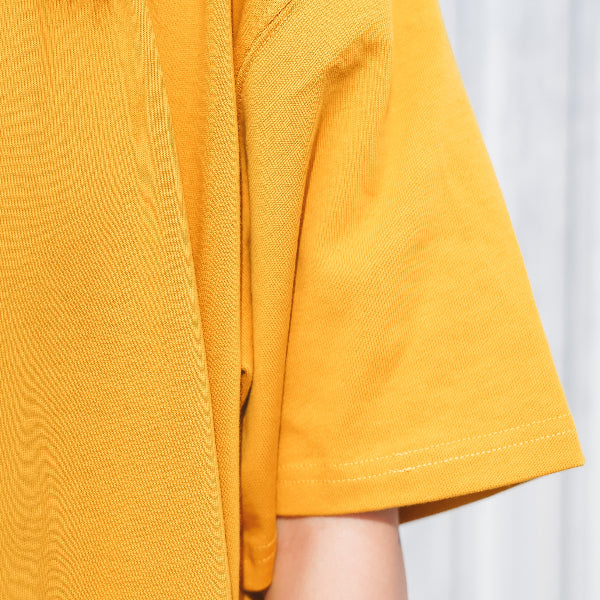 Mustard yellow Yama Basic Color Tee sleeve detail at Grandmama Store in Hong Kong.