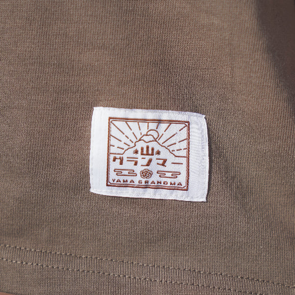 Woven brand logo patch on taupe brown Yama Basic Color Tee at Grandmama Store in Hong Kong.