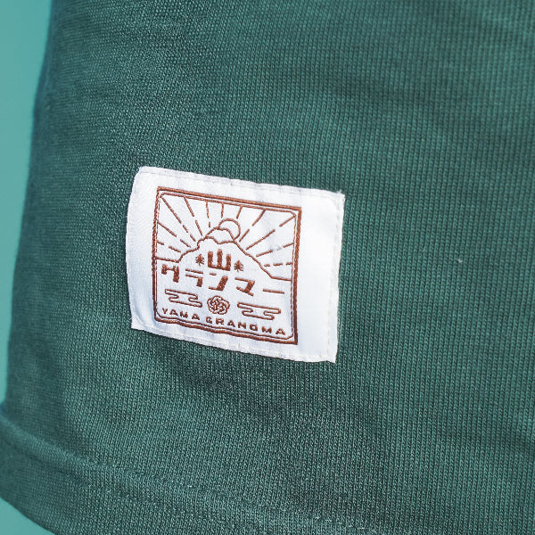 Woven logo label on dark green Yama Basic Color Tee at Grandmama Store in Hong Kong.